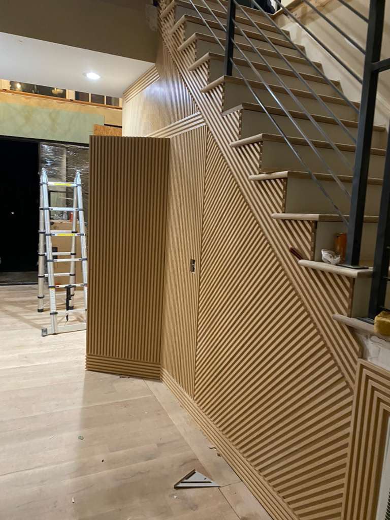 Custom wood slat staircase wall